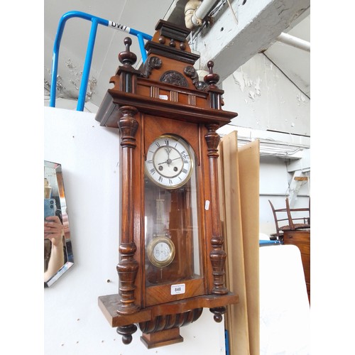 848 - A Vienna wall clock with pendulum and key.