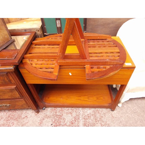 782 - A teak trolley and a folding table.