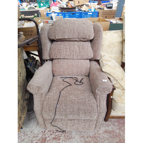 766 - A grey upholstered electric reclining armchair.