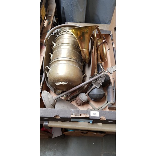 135 - A box of metalware to include two old horns, fire tidy, stackable brass pots, etc.