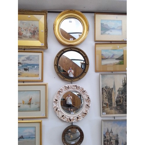 872 - Four convex mirrors, three gilt framed and one other.