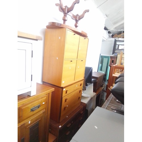 918 - Four pieces of furniture; a utility style chest of drawers, a teak chest of drawers, a side cabinet ... 