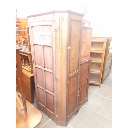 940 - A 1920s oak hallrobe together with an Edwardian walnut music cabinet.