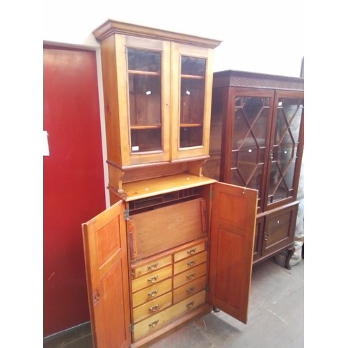 938 - A late Victorian pine secretaire cabinet bookcase, the interior fitted with drawers.