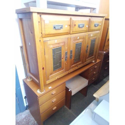 917 - A pine sideboard with brass panels to the doors together with a mid 20th century teak dressing table... 