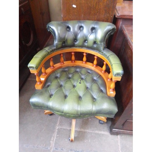 891 - A green leather Chesterfield captain's chair.