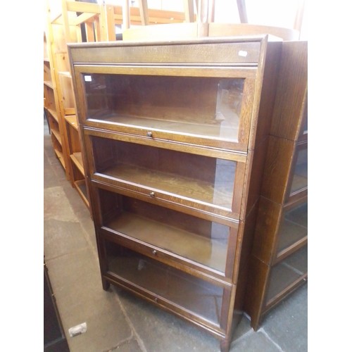 922 - An Oak sectional bookcase by 'GUNN'.