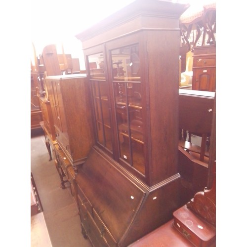 950 - A 1920s oak bureau bookcase.