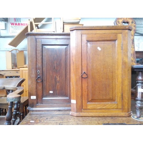 895 - A pair of Georgian oak corner cupboards.