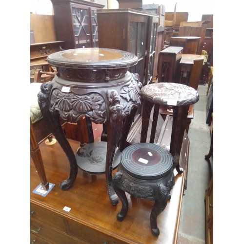 947 - Two Chinese carved wood plant stands/tables together with another carved wood table.