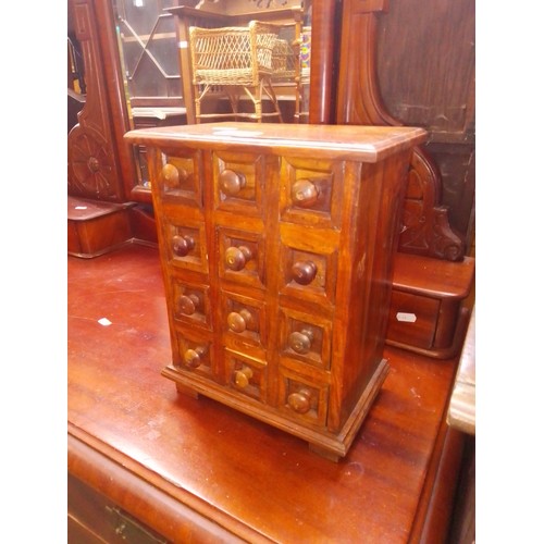 948 - An Indian hardwood miniature chest of drawers.