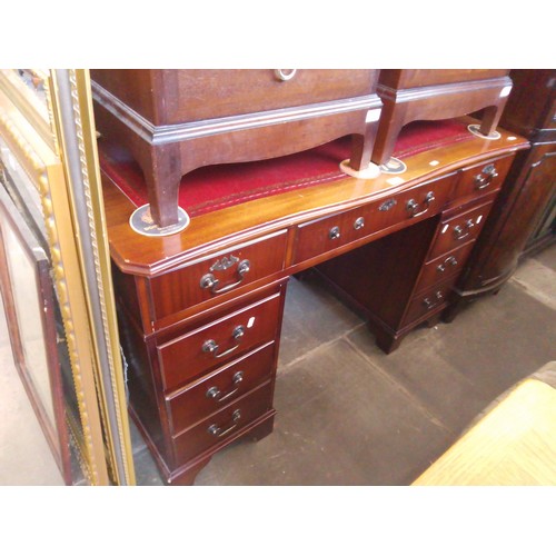 975 - A mahogany pedestal desk with tooled leather writing surface.