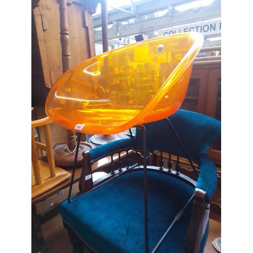 982 - An Italian Pedrali 'Gliss' chair, orange perspex on metal base.