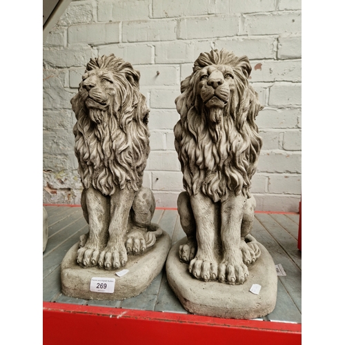 269 - A pair of stoneware garden lion statues. Approx 40cm