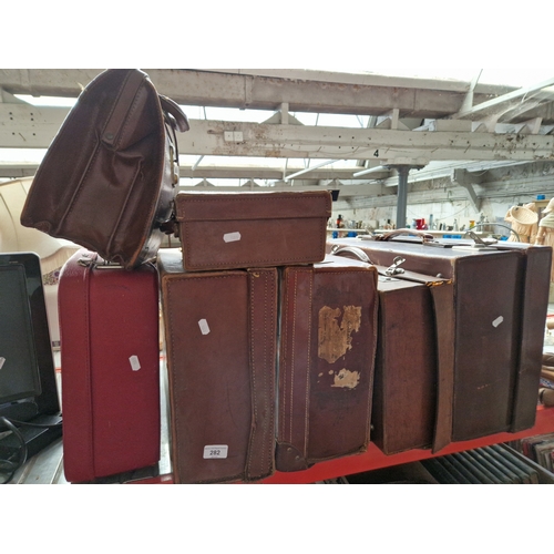 282 - Five leather suitcases and one other modern suitcase