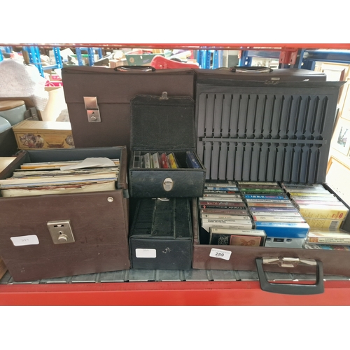 289 - Two cases of vinyl LP records, a case of singles and various cassettes.