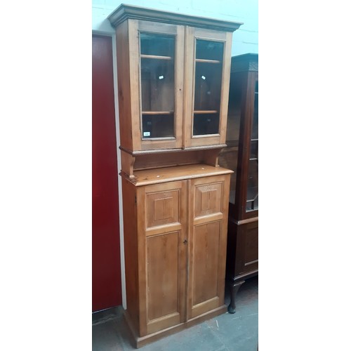 938 - A late Victorian pine secretaire cabinet bookcase, the interior fitted with drawers.