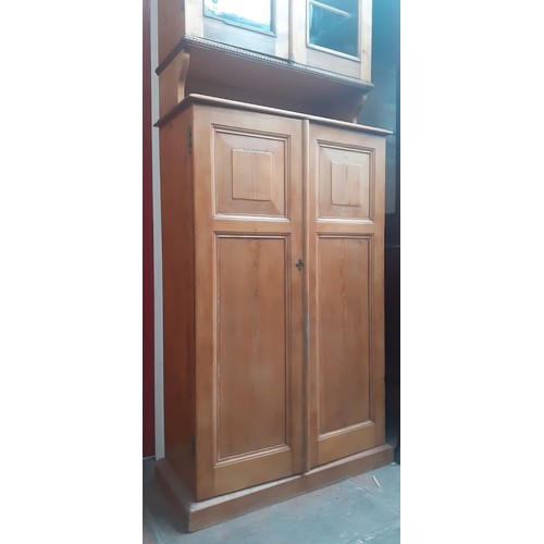 938 - A late Victorian pine secretaire cabinet bookcase, the interior fitted with drawers.