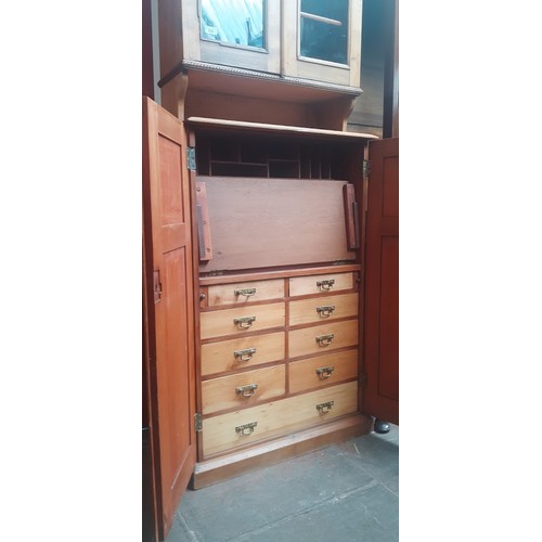 938 - A late Victorian pine secretaire cabinet bookcase, the interior fitted with drawers.