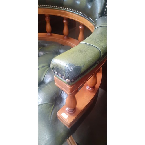 891 - A green leather Chesterfield captain's chair.