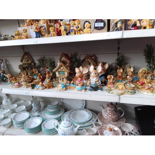 692 - A collection of Pendelfin rabbit figurines including full sets, etc. * display stands and appx 30 fi... 