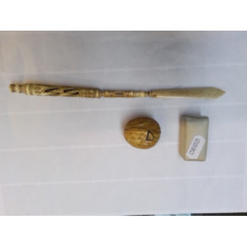 703 - A mixed lot of collectables comprising carved bone pen/letter opener, miniature harmonica and a tape... 