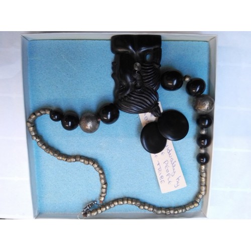 707 - An African ebony and white metal beaded and carved necklace and similar era studs.