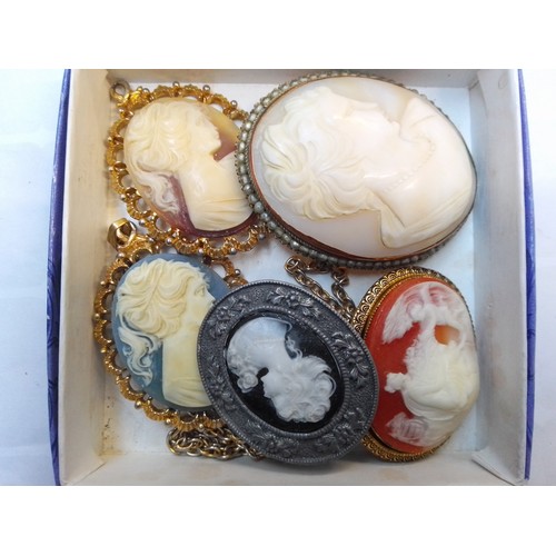 711 - Four cameo brooches/pendants