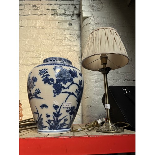 89 - A table lamp and a blue and white vase.