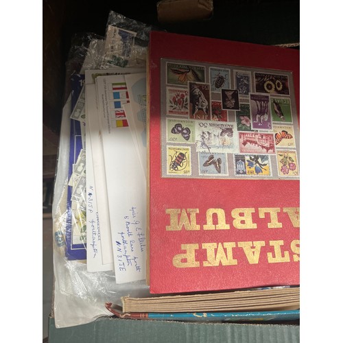 67 - A box of stamps in albums and first day covers