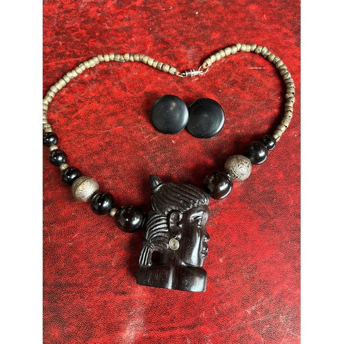 707 - An African ebony and white metal beaded and carved necklace and similar era studs.