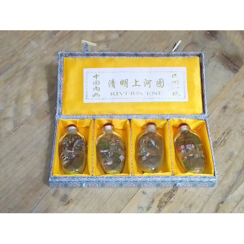 84 - A set of four Chinese 'Riverscne' snuff bottles in case.