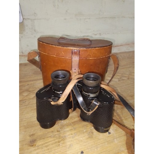 147 - A pair of Negretti & Zambra binoculars with leather case.