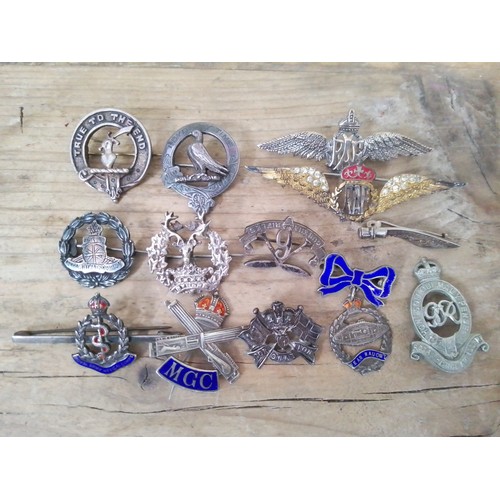 138 - A collection of military sweetheart badges including silver, RAF etc.