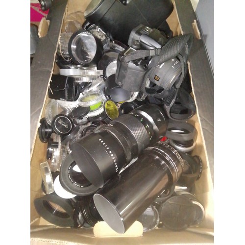 219 - A box of assorted cmaera accessories comprising a large quantity of filters and lens cpas, a Pentaco... 