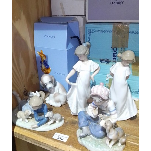 299 - Three Lladro figures, two Nao figures and a Wedgwood Peter Rabbit nursery set.