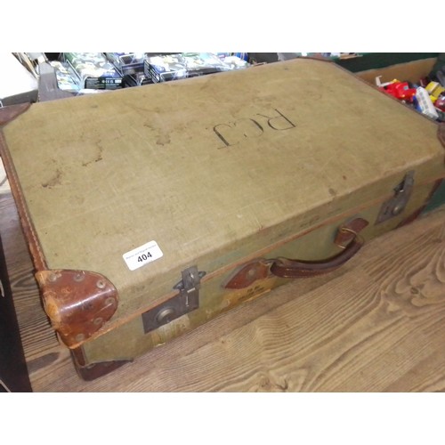 404 - A WWII leather trimmed suitcase containing militaria inlcuding navy jacket and trousers, white jacke... 