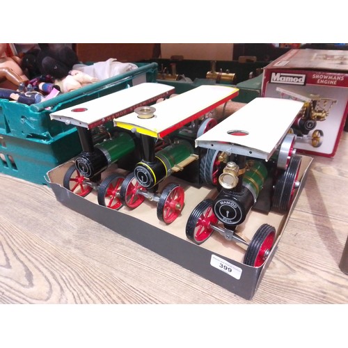 399 - A group of three Mamod live steam tractors and one log trailer.