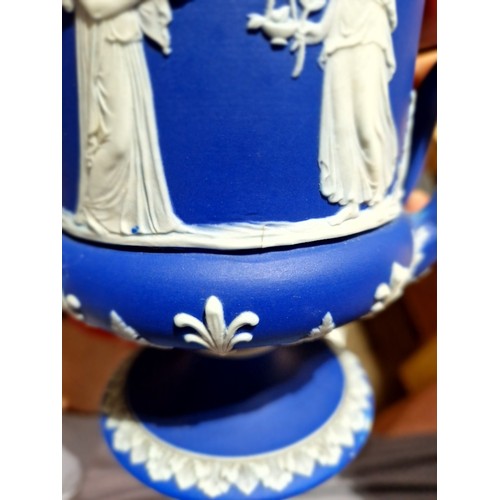 278 - Wedgwood comprising a pair of lidded urns, a pedestal vase and two Dancing Hour figures.