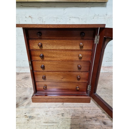 34 - A late Victorian specimen cabinet, interior drawers with arched glazed door, labelled 'Watkins & Don... 