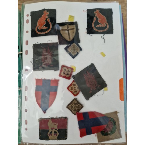 142 - Three albums of military badges, patches and buttons.