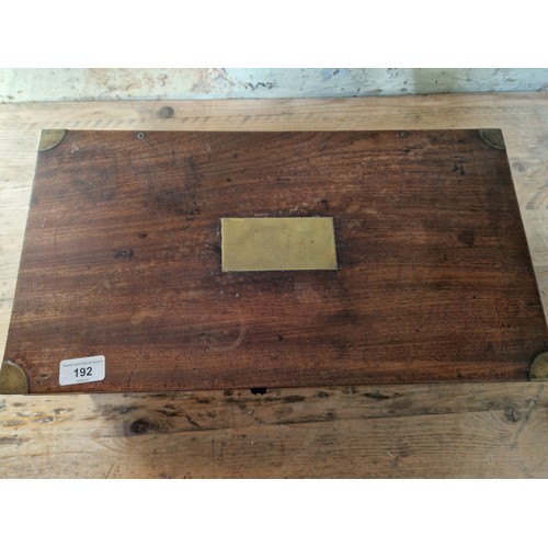 192 - A 19th century mahogany writing slope, campaign style with inset brass handles and brass inlaid corn... 