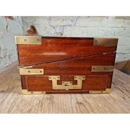 193 - A 19th century mahogany writing slope with campaign style inset brass handles and inlaid brass corne... 