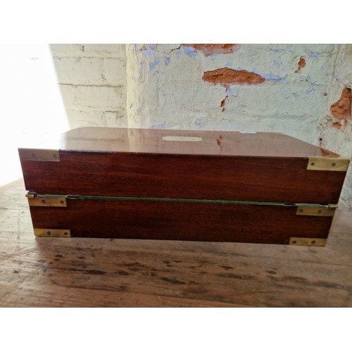 193 - A 19th century mahogany writing slope with campaign style inset brass handles and inlaid brass corne... 