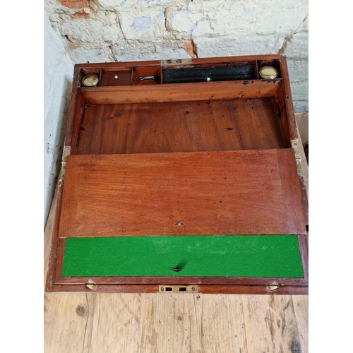 193 - A 19th century mahogany writing slope with campaign style inset brass handles and inlaid brass corne... 