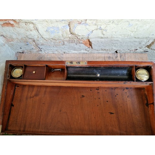 193 - A 19th century mahogany writing slope with campaign style inset brass handles and inlaid brass corne... 