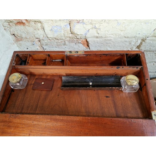 193 - A 19th century mahogany writing slope with campaign style inset brass handles and inlaid brass corne... 