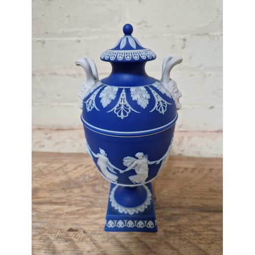 278 - Wedgwood comprising a pair of lidded urns, a pedestal vase and two Dancing Hour figures.