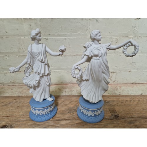 278 - Wedgwood comprising a pair of lidded urns, a pedestal vase and two Dancing Hour figures.