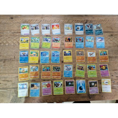 384 - A large box of Pokemon trade cards.